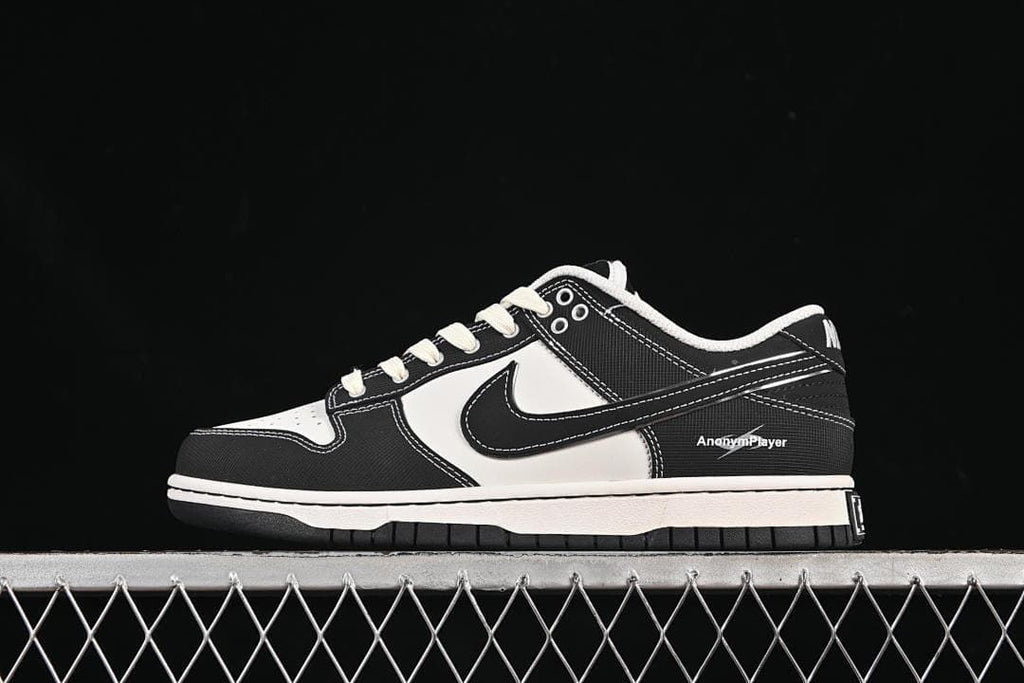 Side view of a black-and-white low-top Nike SB Dunk sneaker