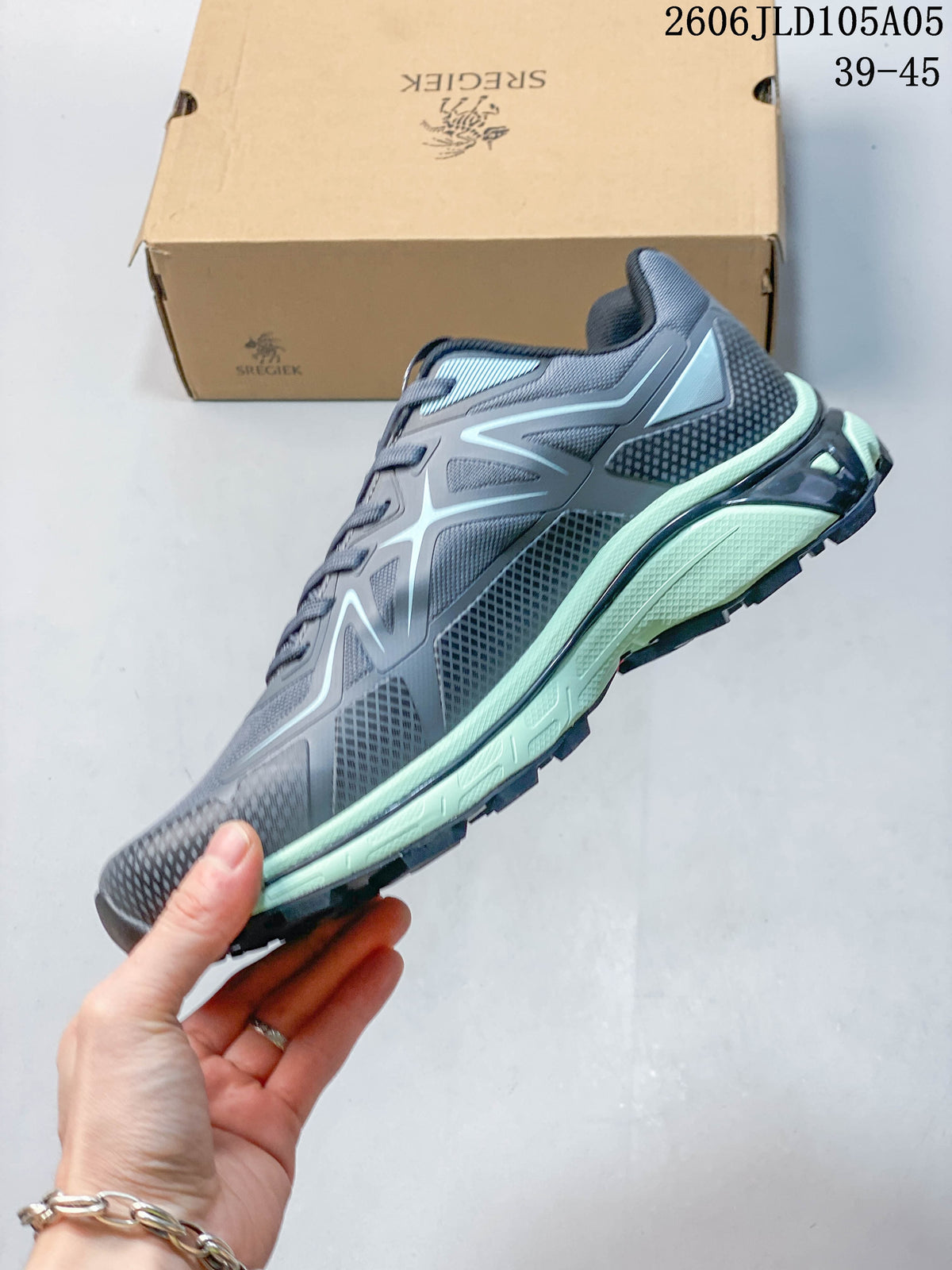 Side view of the gray trail shoe with pale mint midsole accents