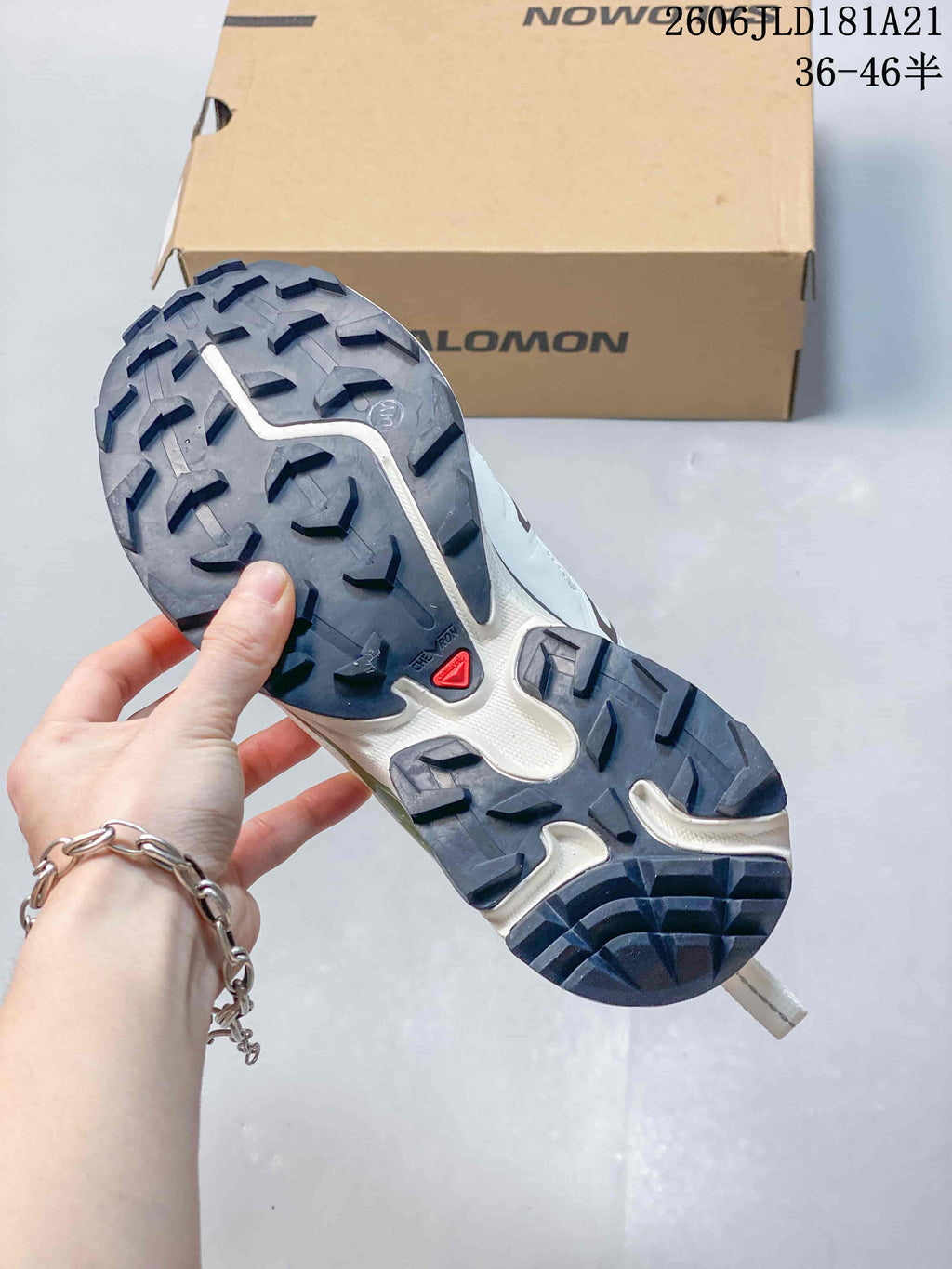 Close-up of the sneaker outsole showing raised tread and dark lugs.