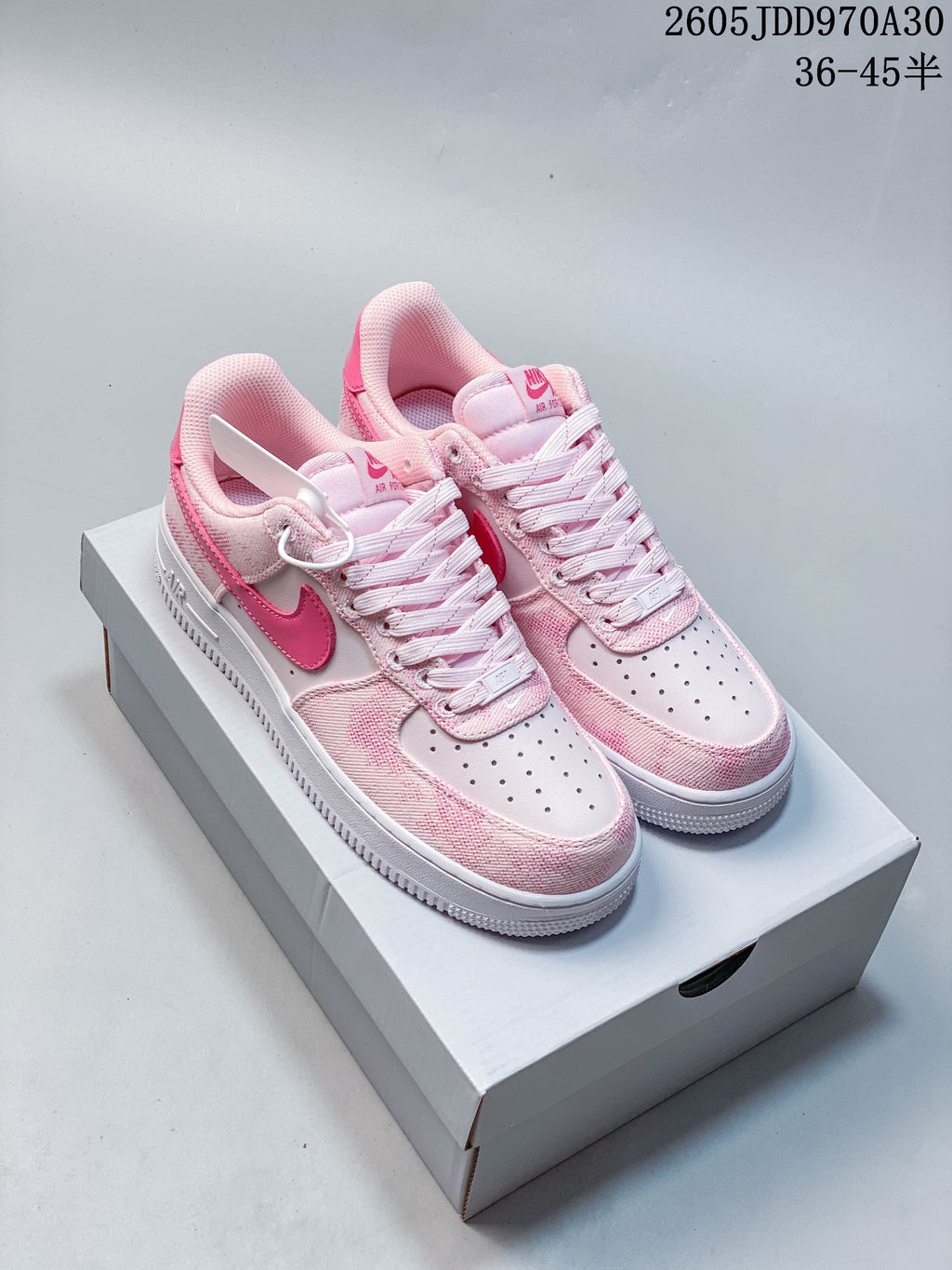 Pink Nike Air Force 1 ’07 low-top sneakers with white laces and a white midsole