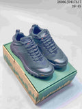 Pair of dark gray low-cut Danner shoes with lace-up fronts on a green and tan shoe box.
