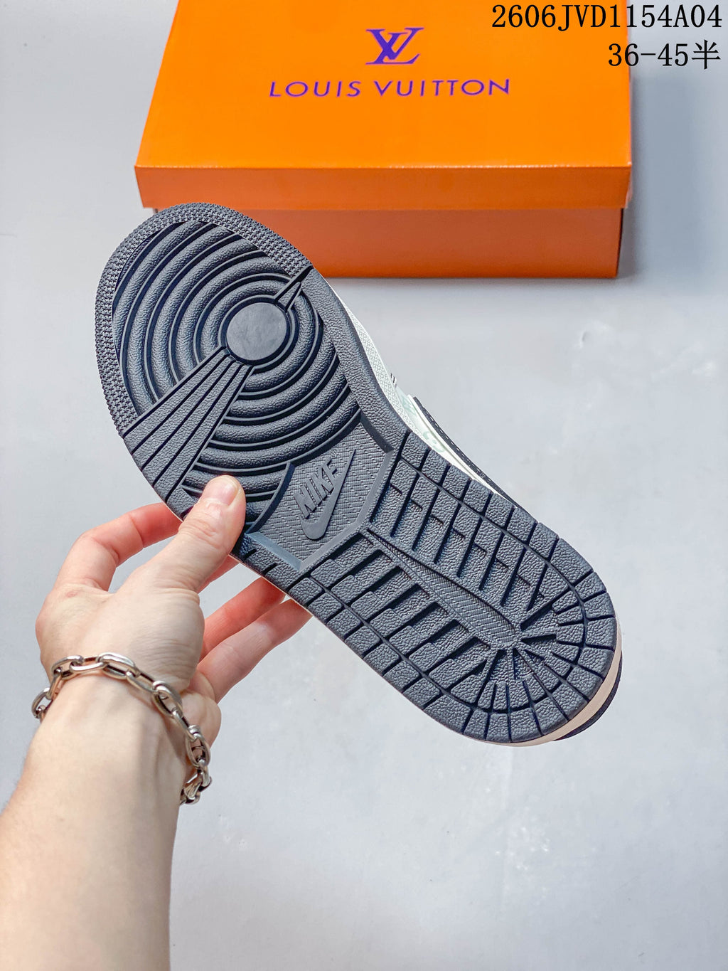View of the dark navy patterned outsole on an off-white low-top sneaker.