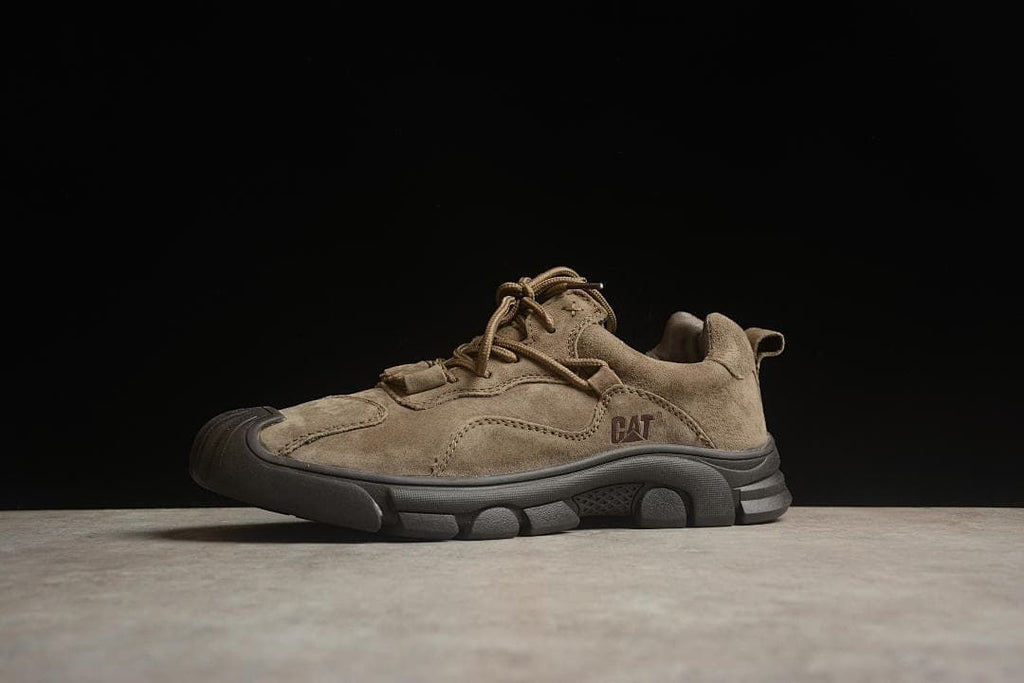 Side view showing the CAT logo, stitched panels, and treaded sole.