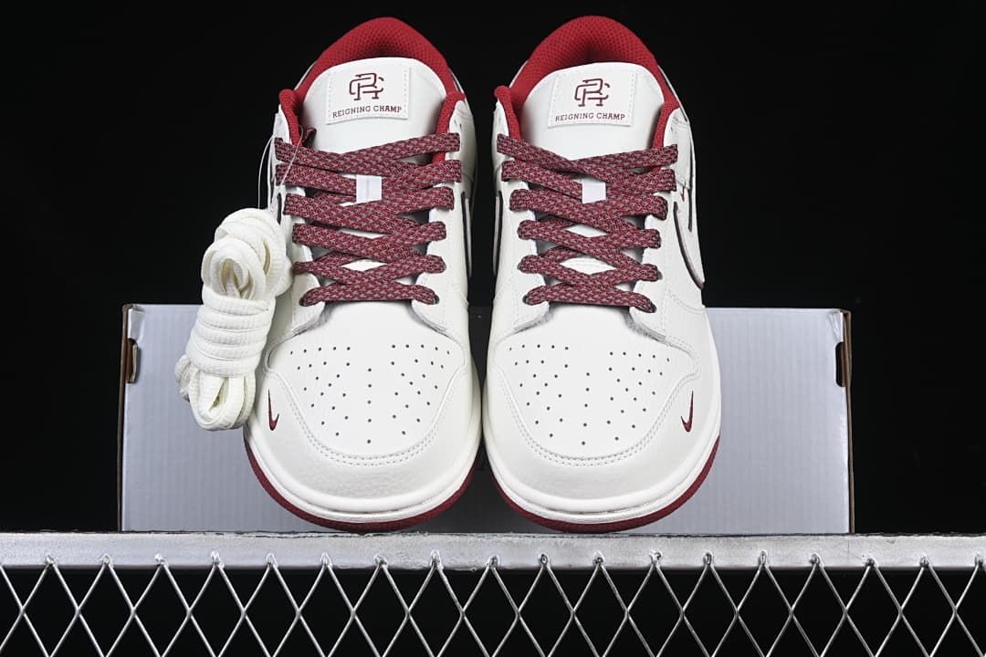 Front view of the pair with patterned burgundy laces and spare white laces