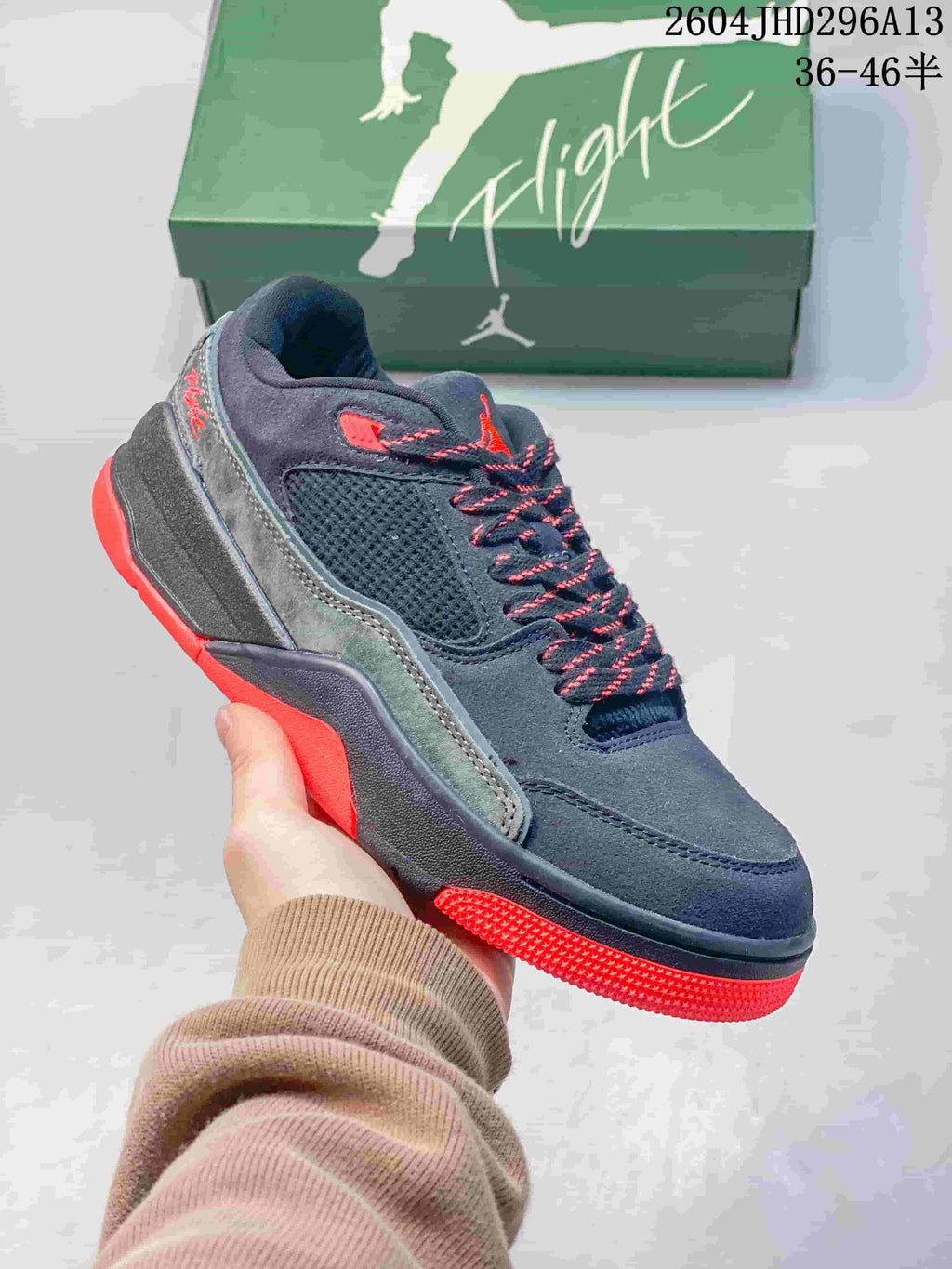 Angled side view highlighting the mesh panel, gray overlays, and red outsole.