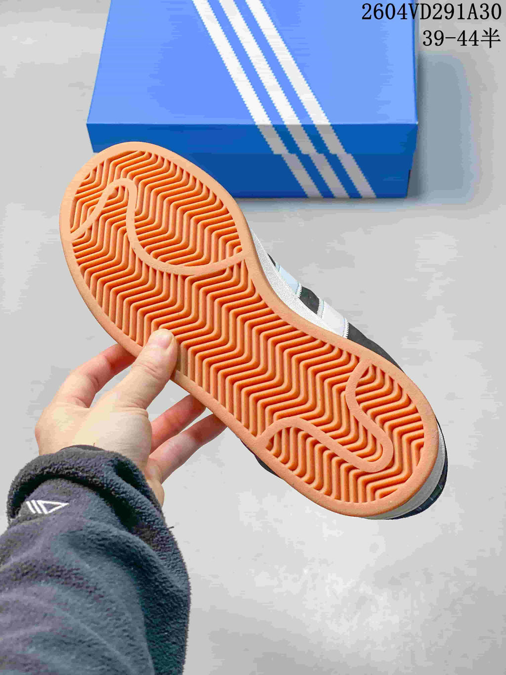 Close-up of the gum-colored outsole with a herringbone tread pattern