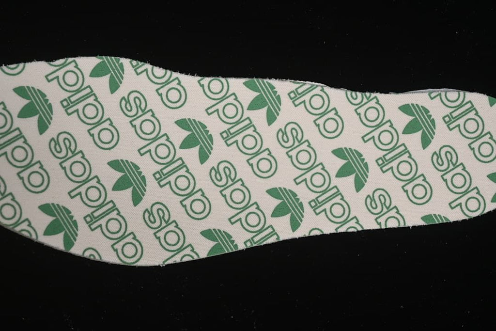 Close-up of an insole printed with adidas branding