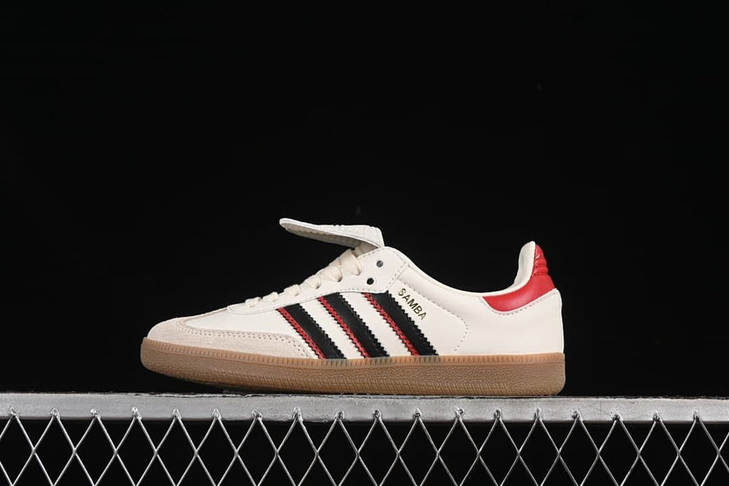 Side view of an off-white adidas Samba LT with black and red stripes, red heel detail, and gum-colored outsole.