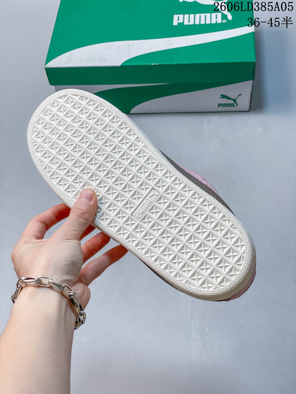 Close-up of the textured geometric outsole on a pink PUMA sneaker