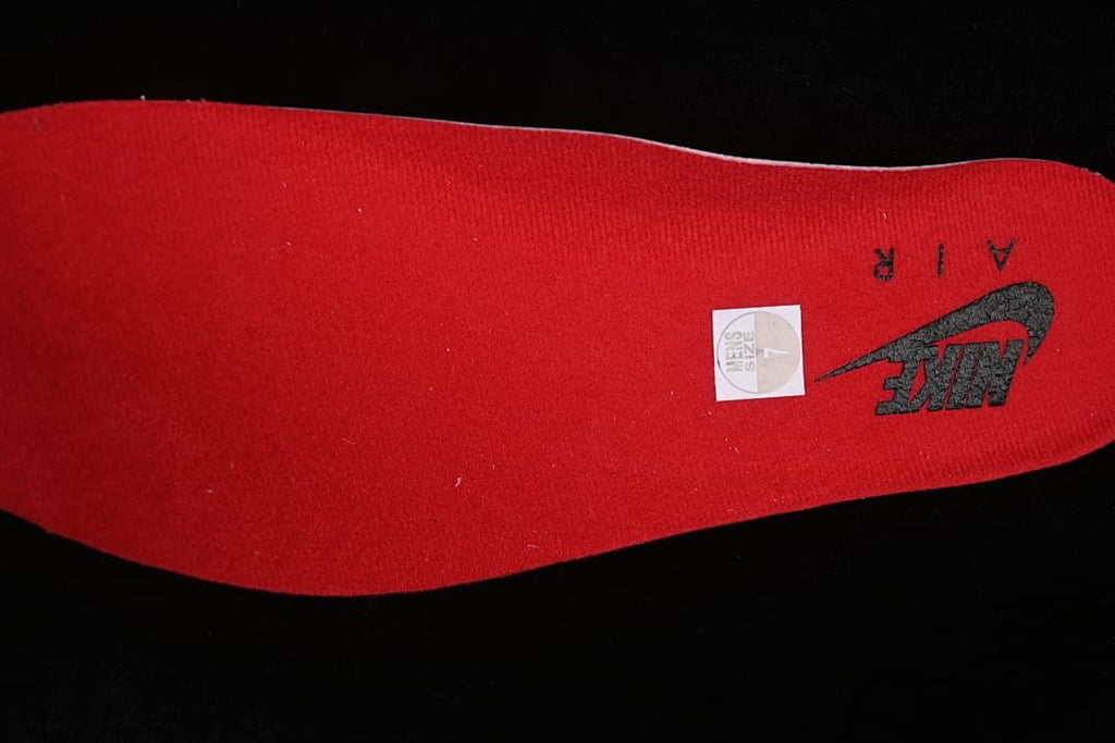 Red insole with a size sticker marked 7