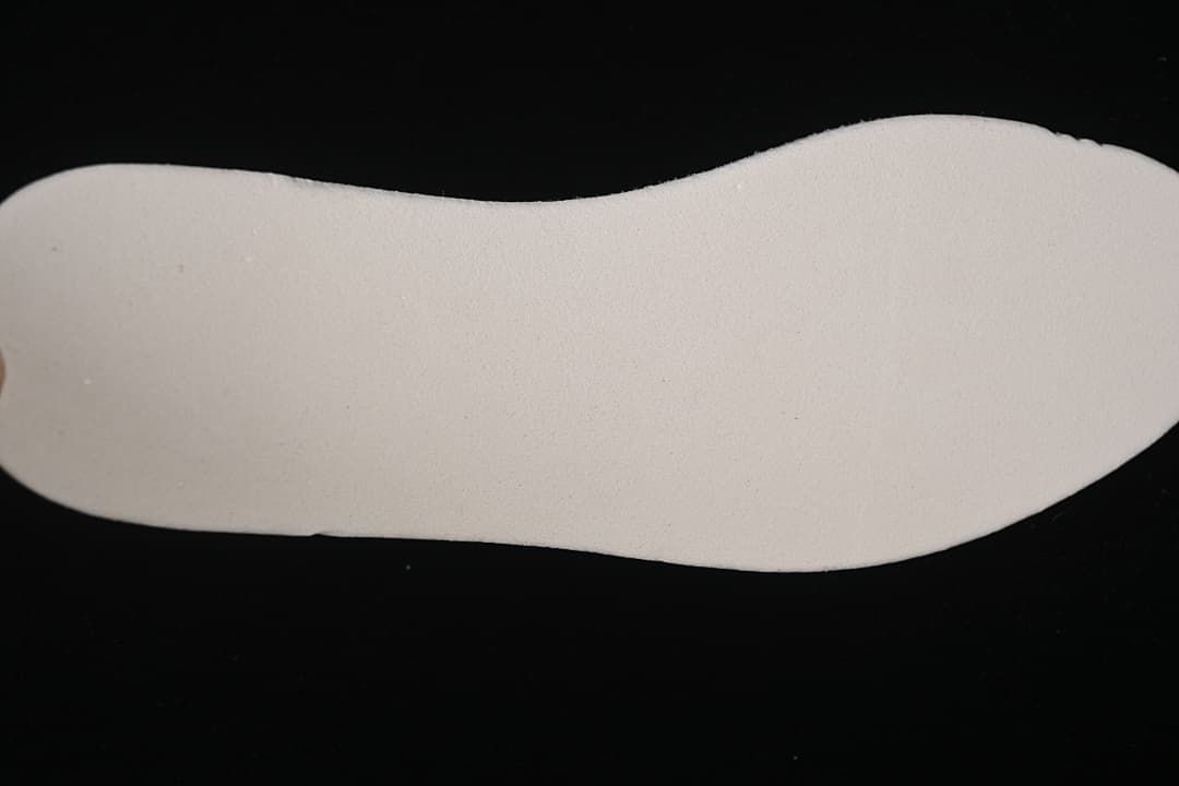 View of the light-colored insole removed from the sneaker.