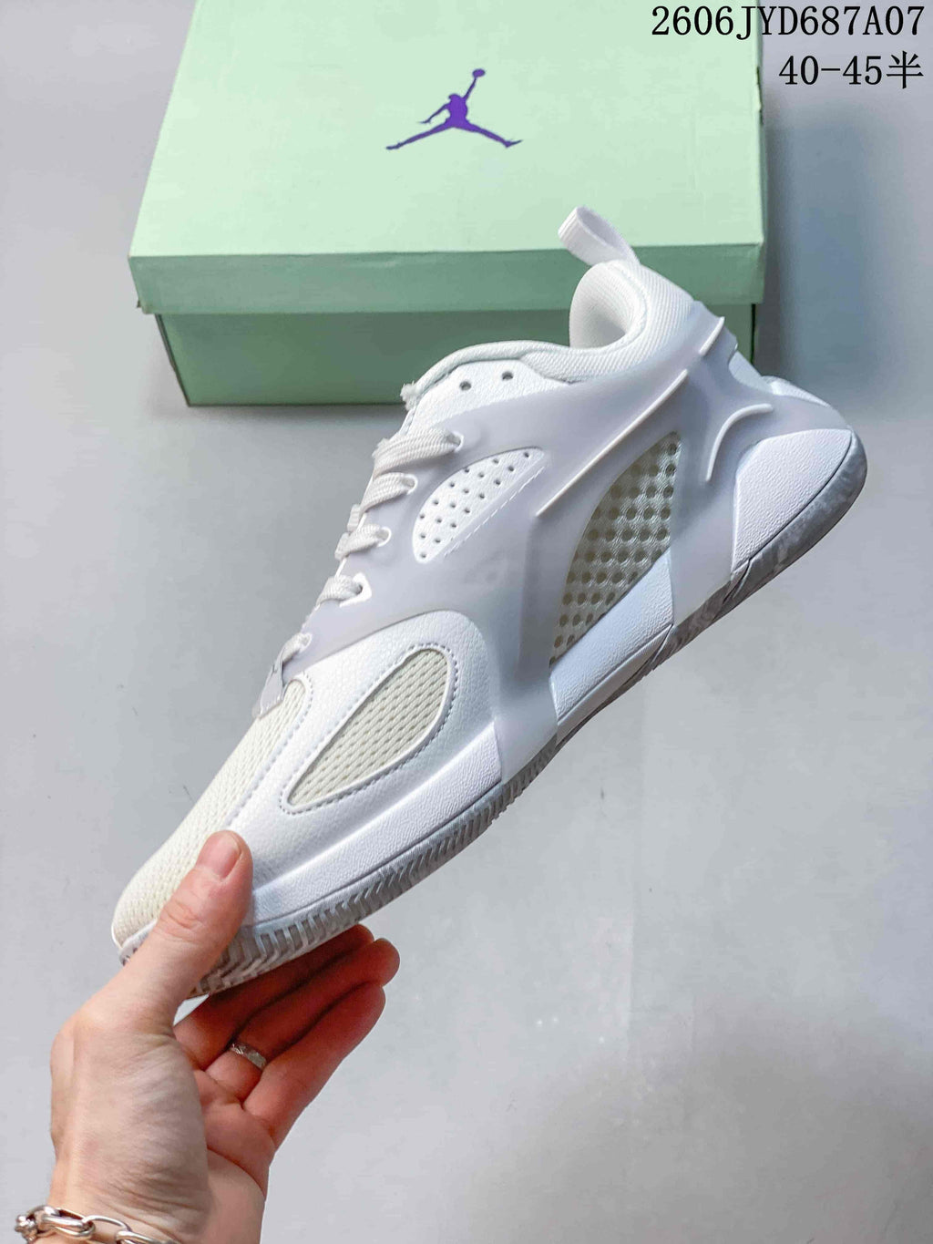 Side view showing the cage-style overlay and mesh-like panels on the Jordan Heir PF.