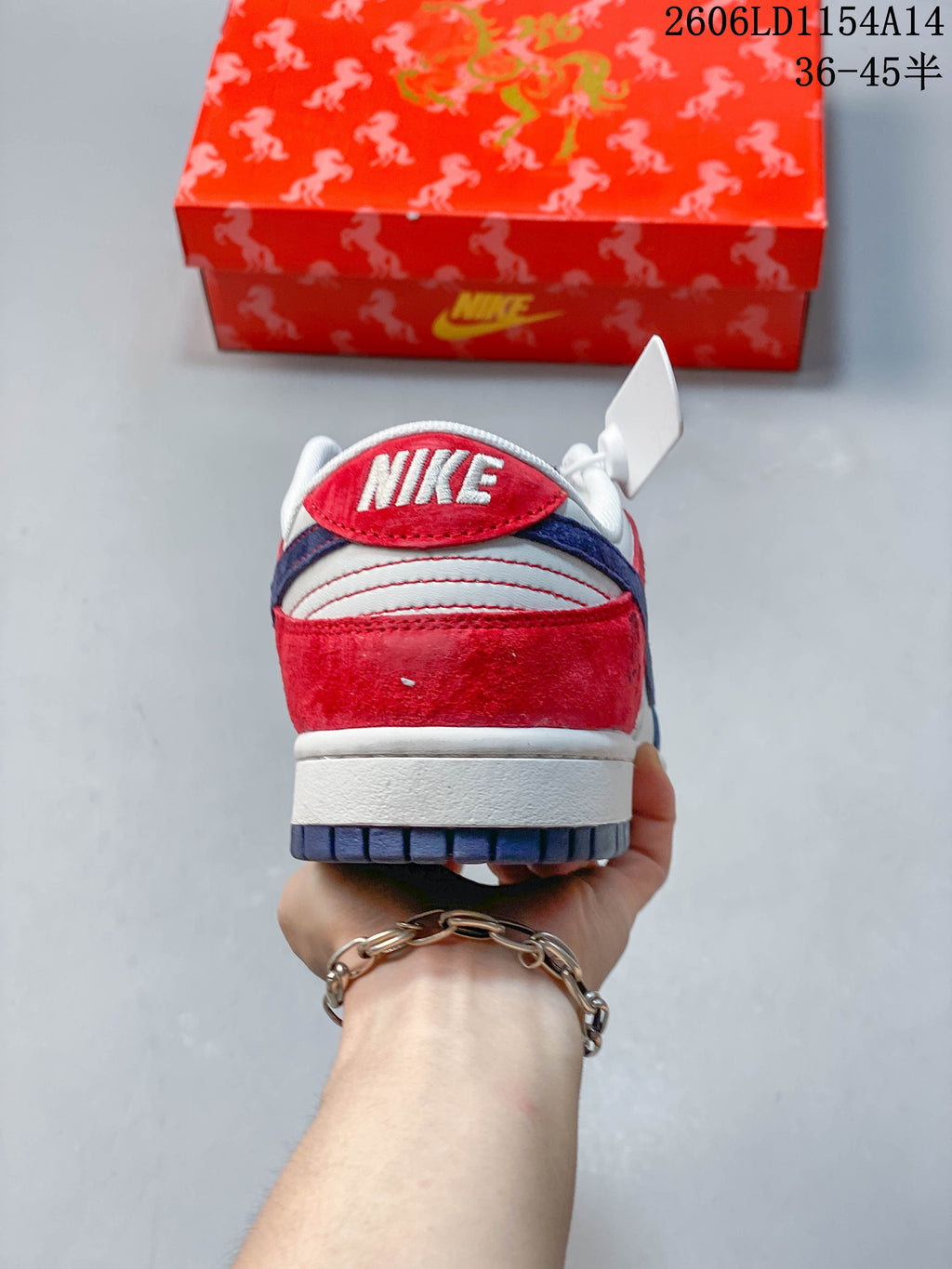 Rear view of the red, white, and blue Nike SB Dunk Low sneaker