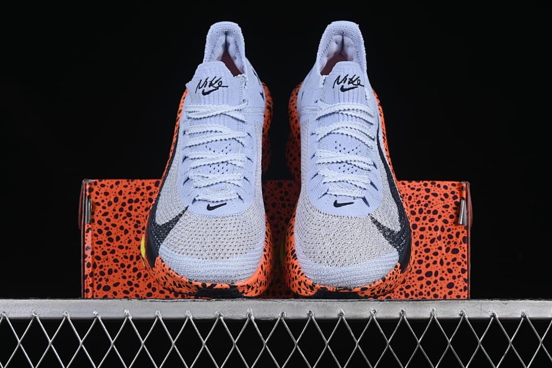 Front view of the pair positioned on the patterned shoe box.