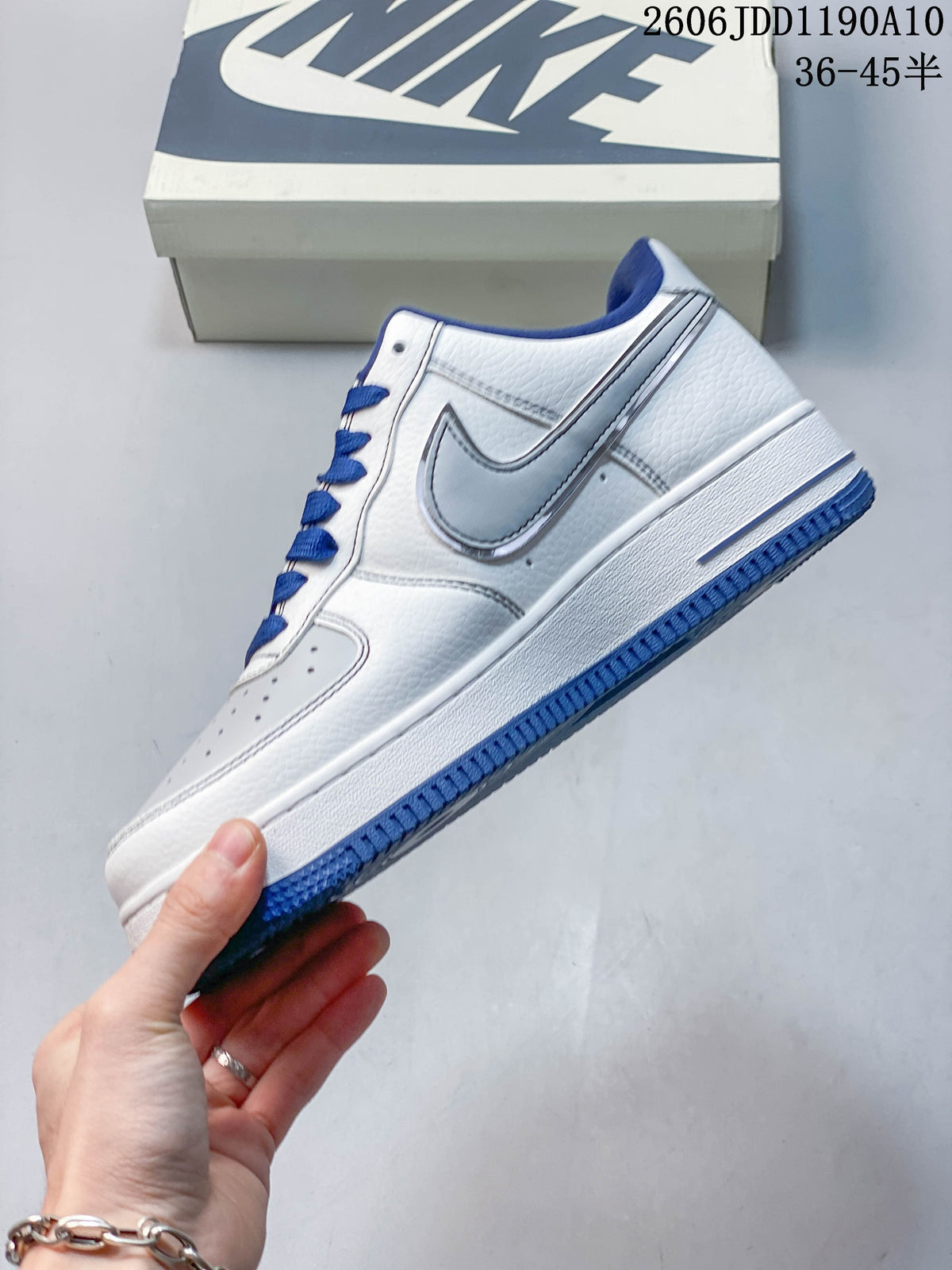 Side view showing the white upper, blue outsole and contrasting side detail