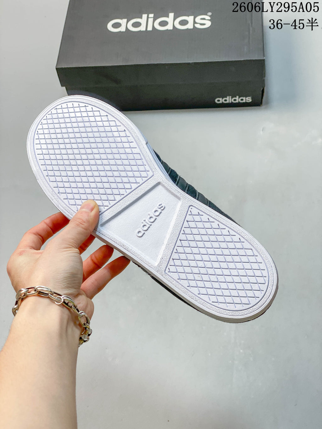 Underside of the sneaker showing a white rubber sole with patterned tread