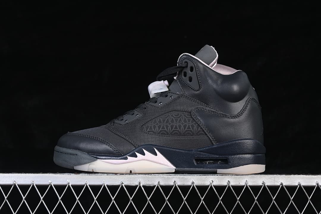 Side view of a black Air Jordan 5 Retro PSG sneaker with pale pink and light-colored sole accents