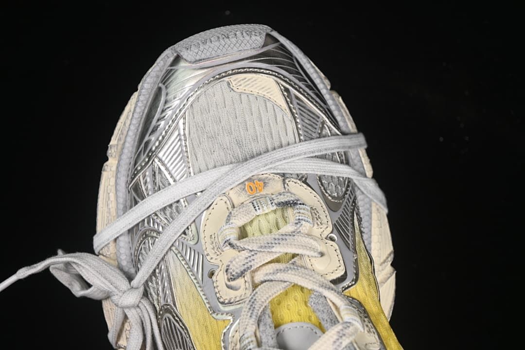 Top-down close-up of the sneaker's lacing and toe area