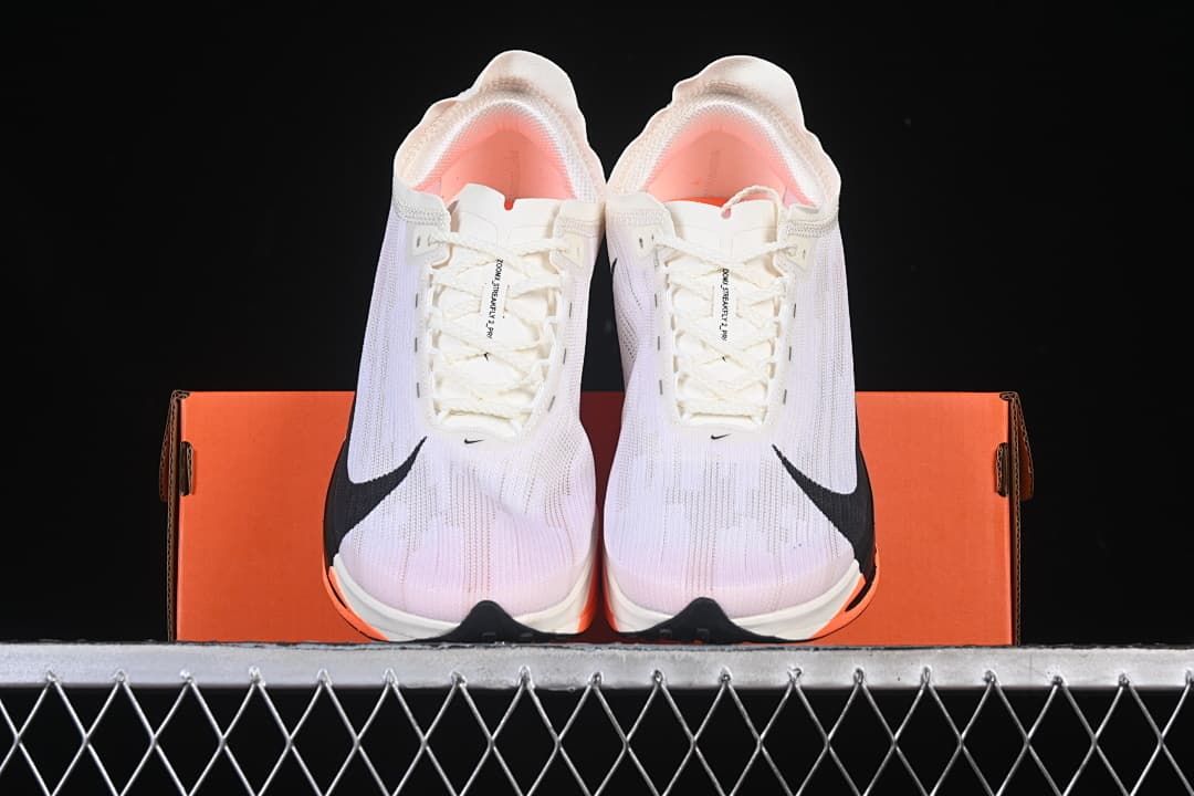 Front view of the pair displayed on an orange shoe box.