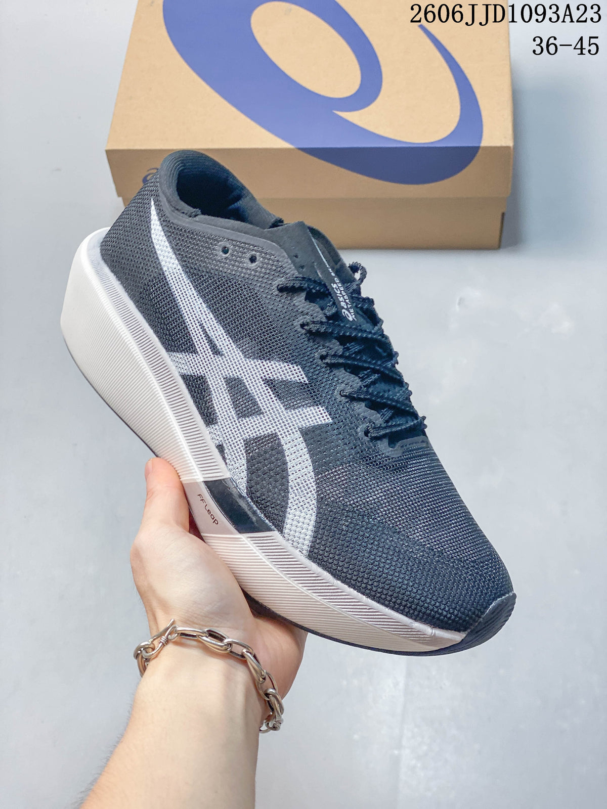 Side view of a dark navy ASICS running shoe with a white logo and pale sole