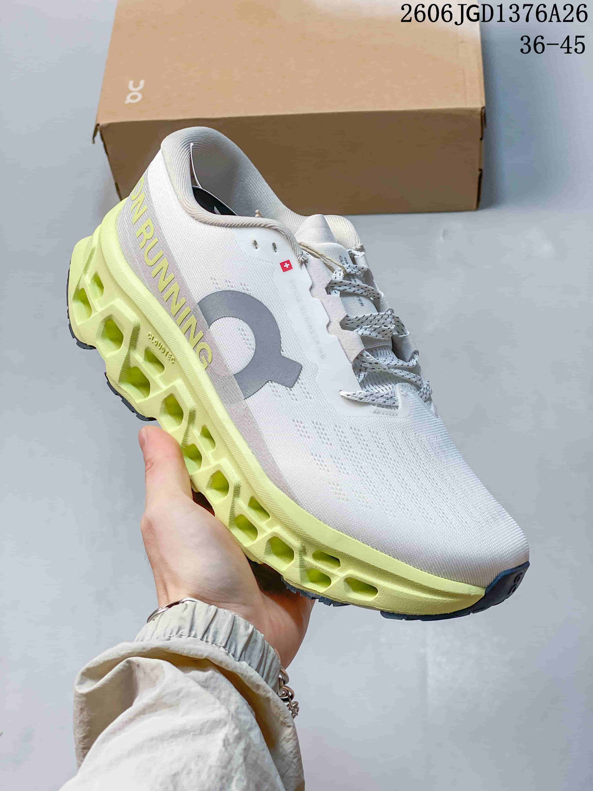 Side view of a white On Cloudmonster 3 shoe with lime open-channel midsole details.