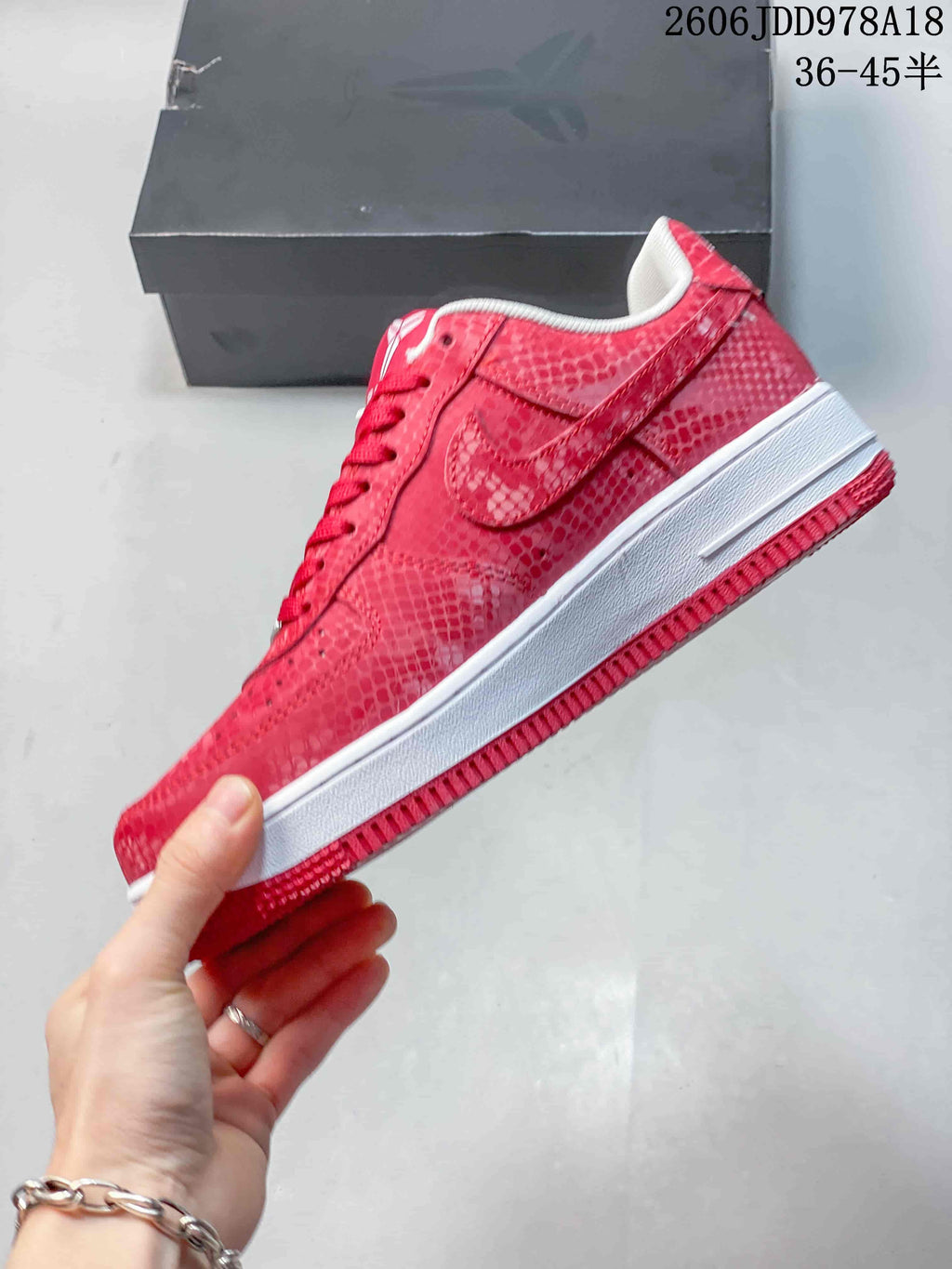 Side view of a red patterned low-top sneaker with a white midsole
