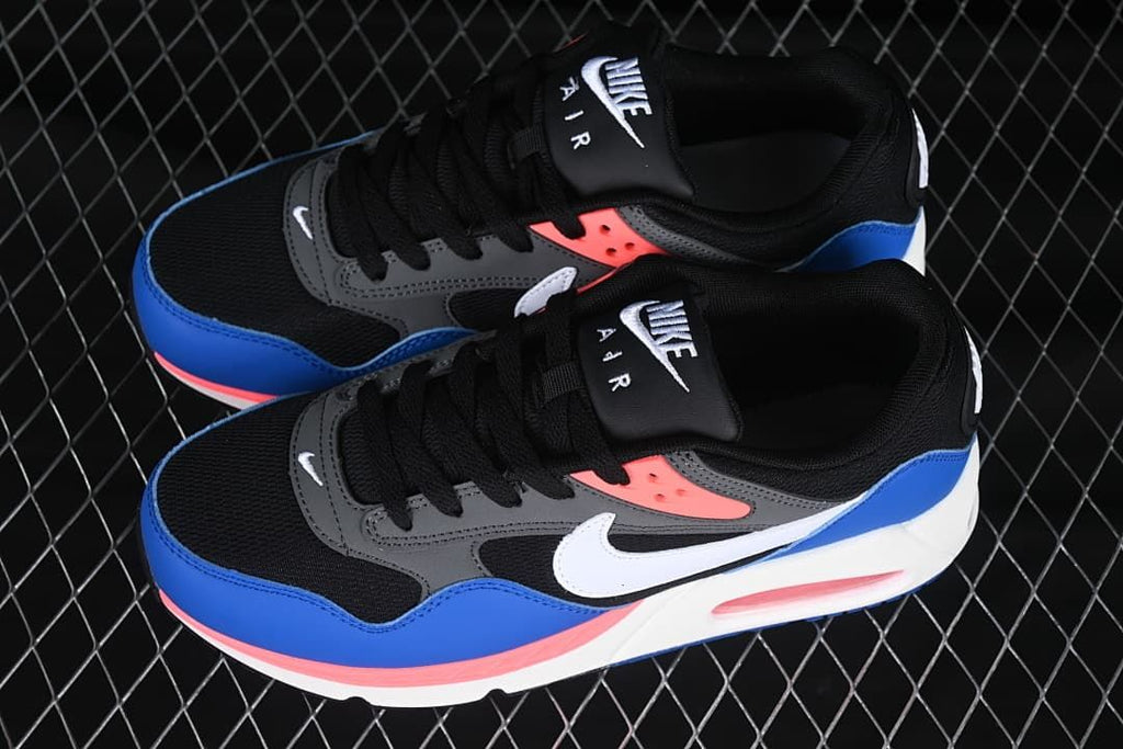 Pair of Nike Air Max Correlate sneakers in blue, black, gray, white, and coral