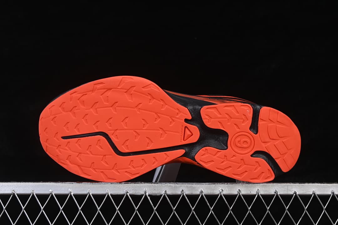 Outsole view showing the tomato-red tread and black sections