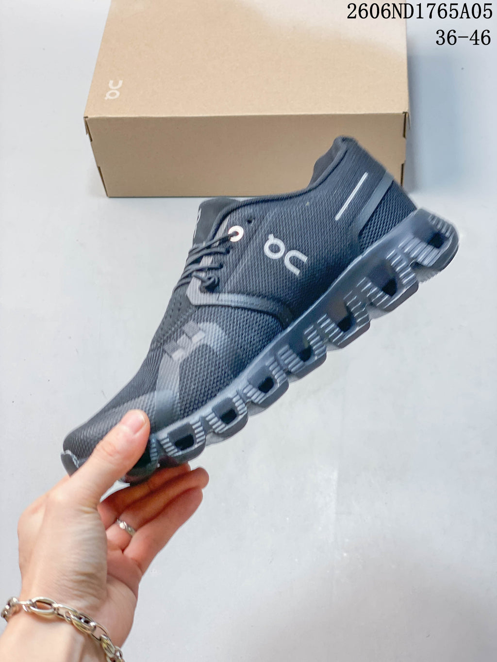 Side view of a dark gray On Cloud 5 sneaker with elastic laces.