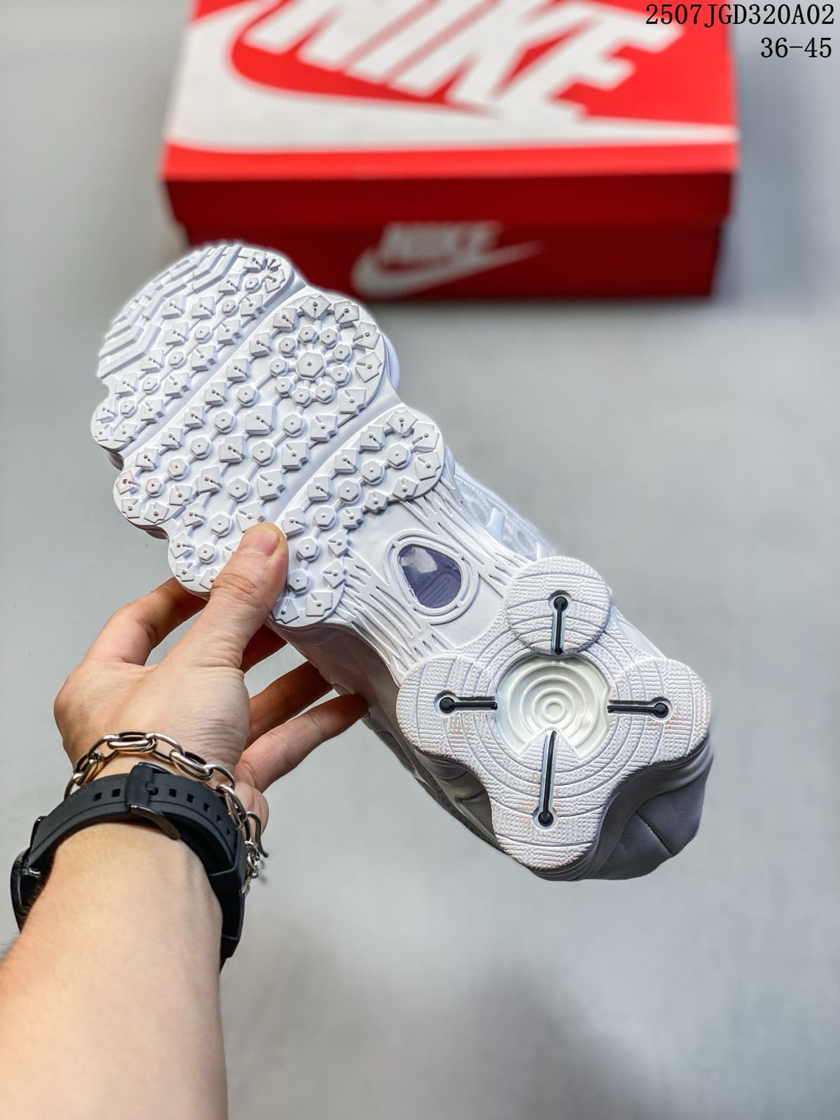 Underside view of the white sneaker showing its patterned outsole