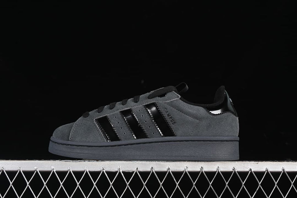 Side view of a charcoal gray adidas Campus 00s sneaker with black stripes and dark sole