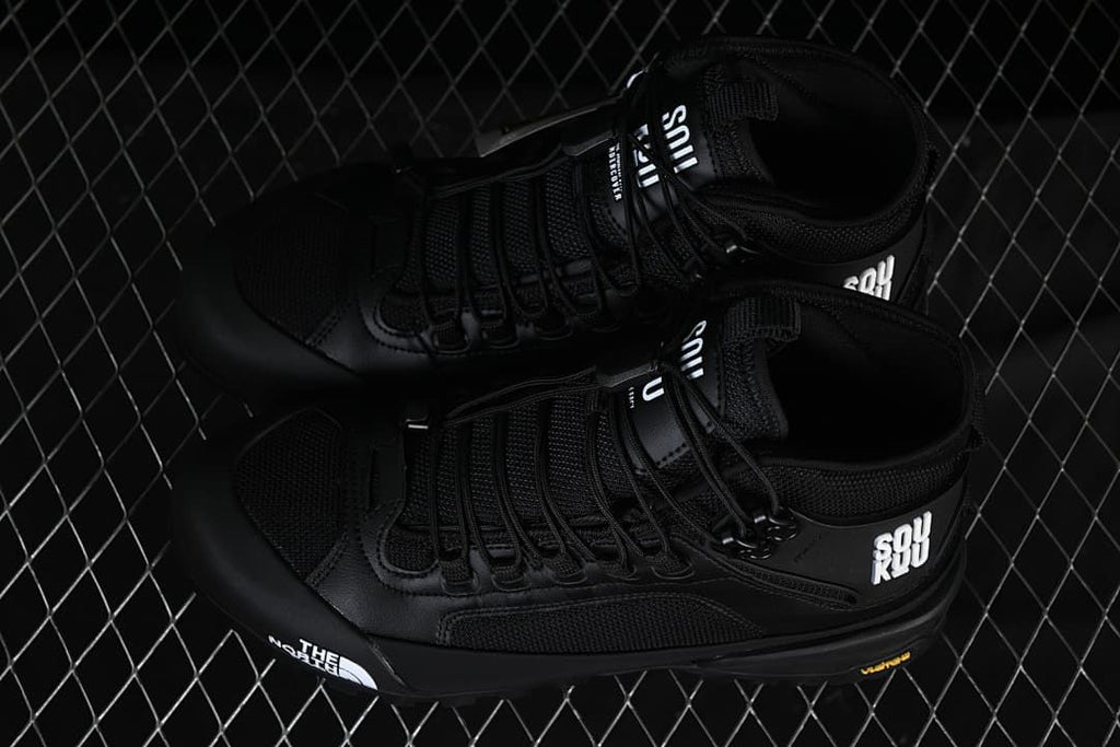 Pair of black mid-height hiking shoes viewed from above