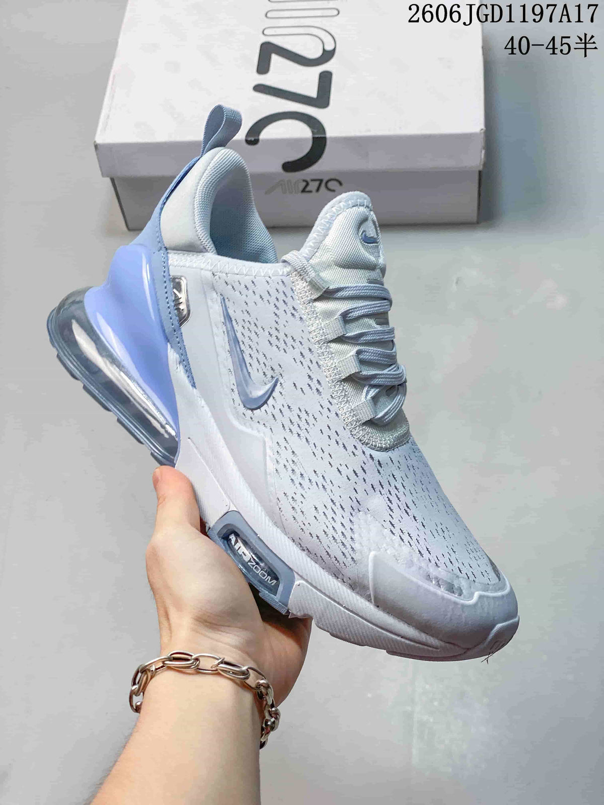 Close-up of a white Nike Air Max Pulse shoe with pale blue accents and a visible heel air unit.