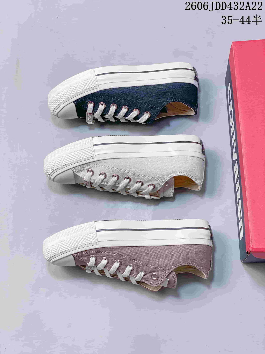 Three low-top sneakers shown from the side in navy, off-white, and mauve