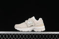 Side view of light beige kids’ New Balance 2002R sneakers with a hook-and-loop strap and white sole