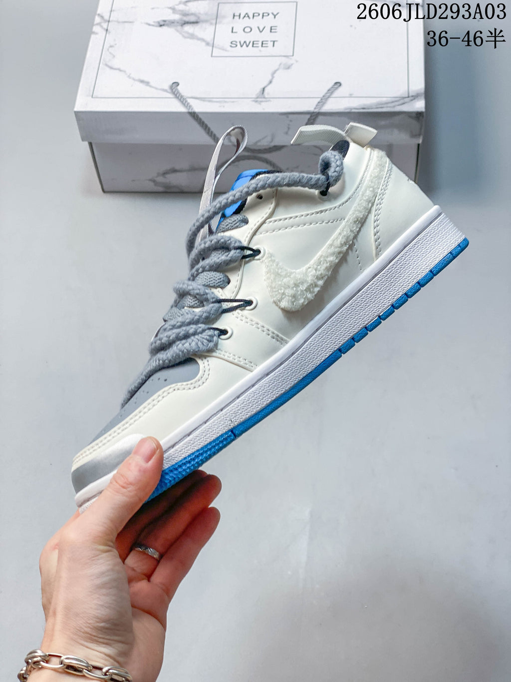 Side view of a low-top sneaker with textured side accent and blue outsole