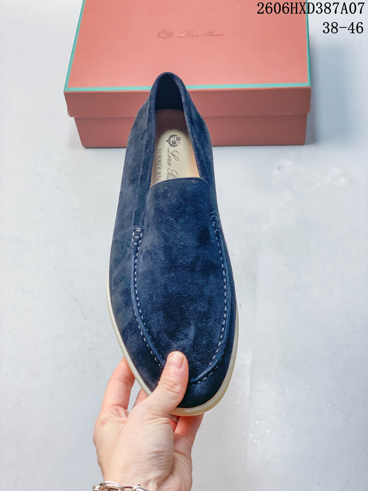 Top view of a navy loafer showing the stitched apron toe