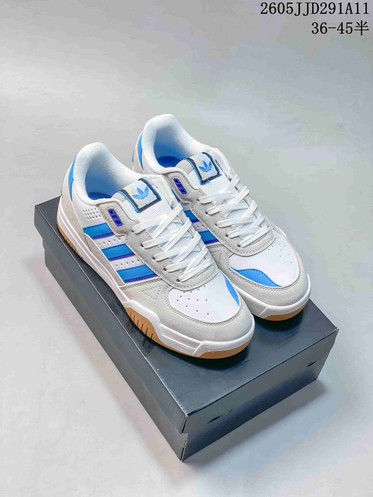Pair of white and light gray Adidas Originals Tekkira Cup sneakers with blue accents and gum-colored outsoles