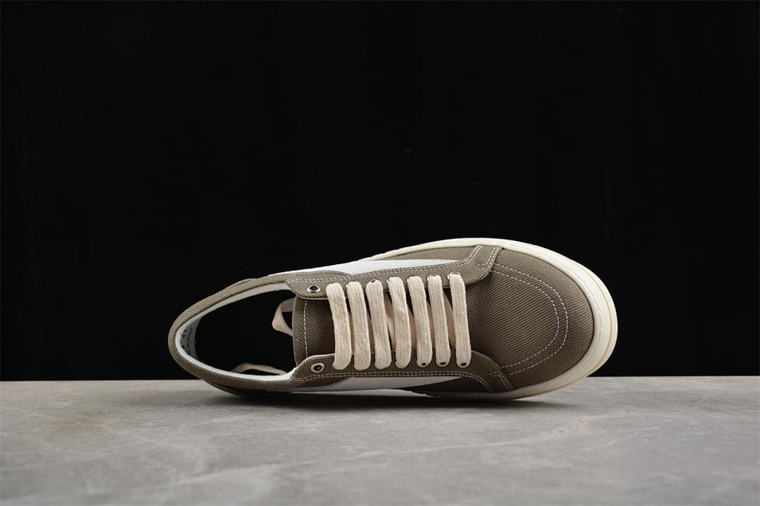 Top view of a brown canvas lace-up sneaker with cream laces