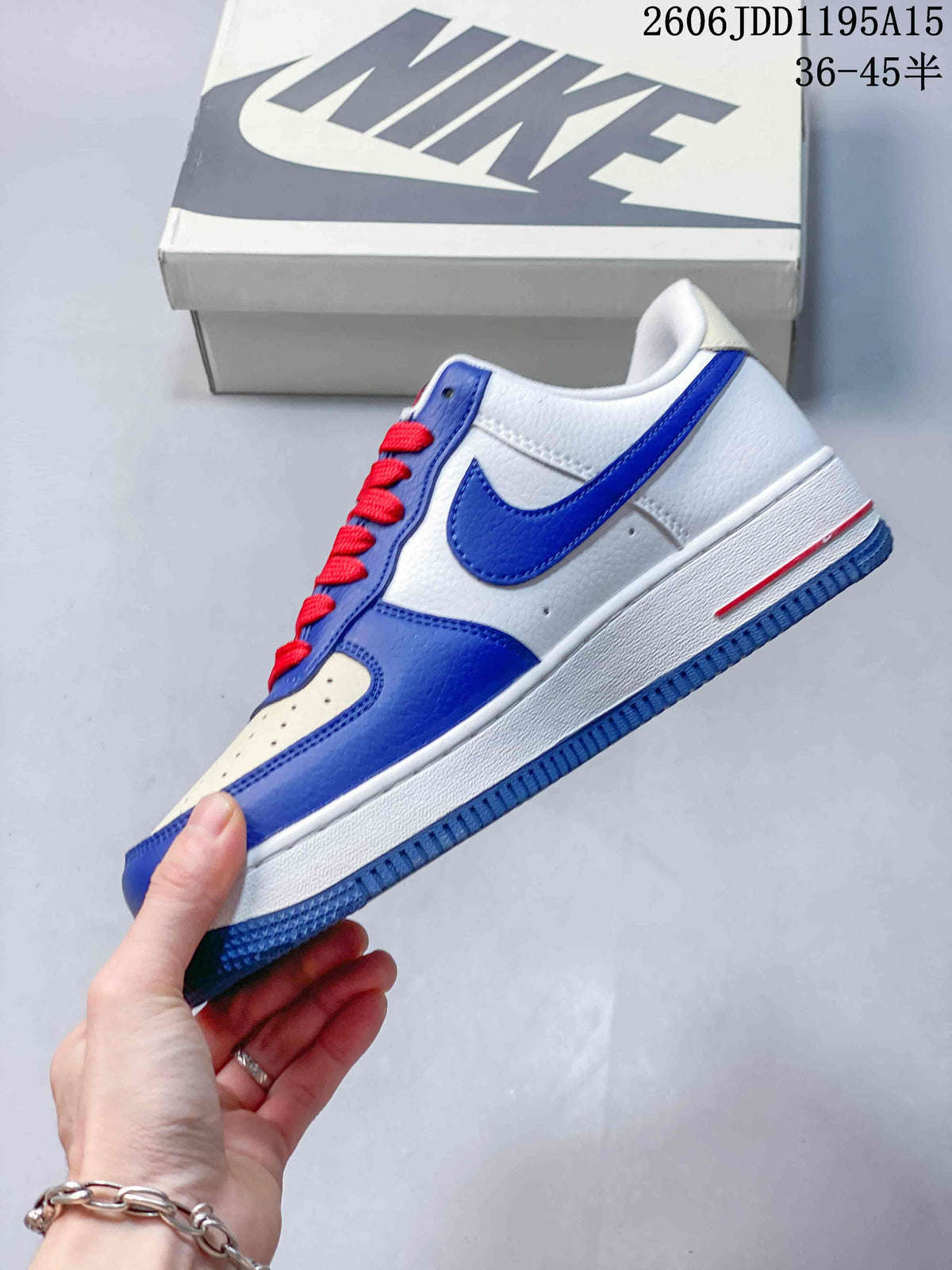Side view showing blue overlays, a white upper and red accents on a Nike Air Force 1 Low