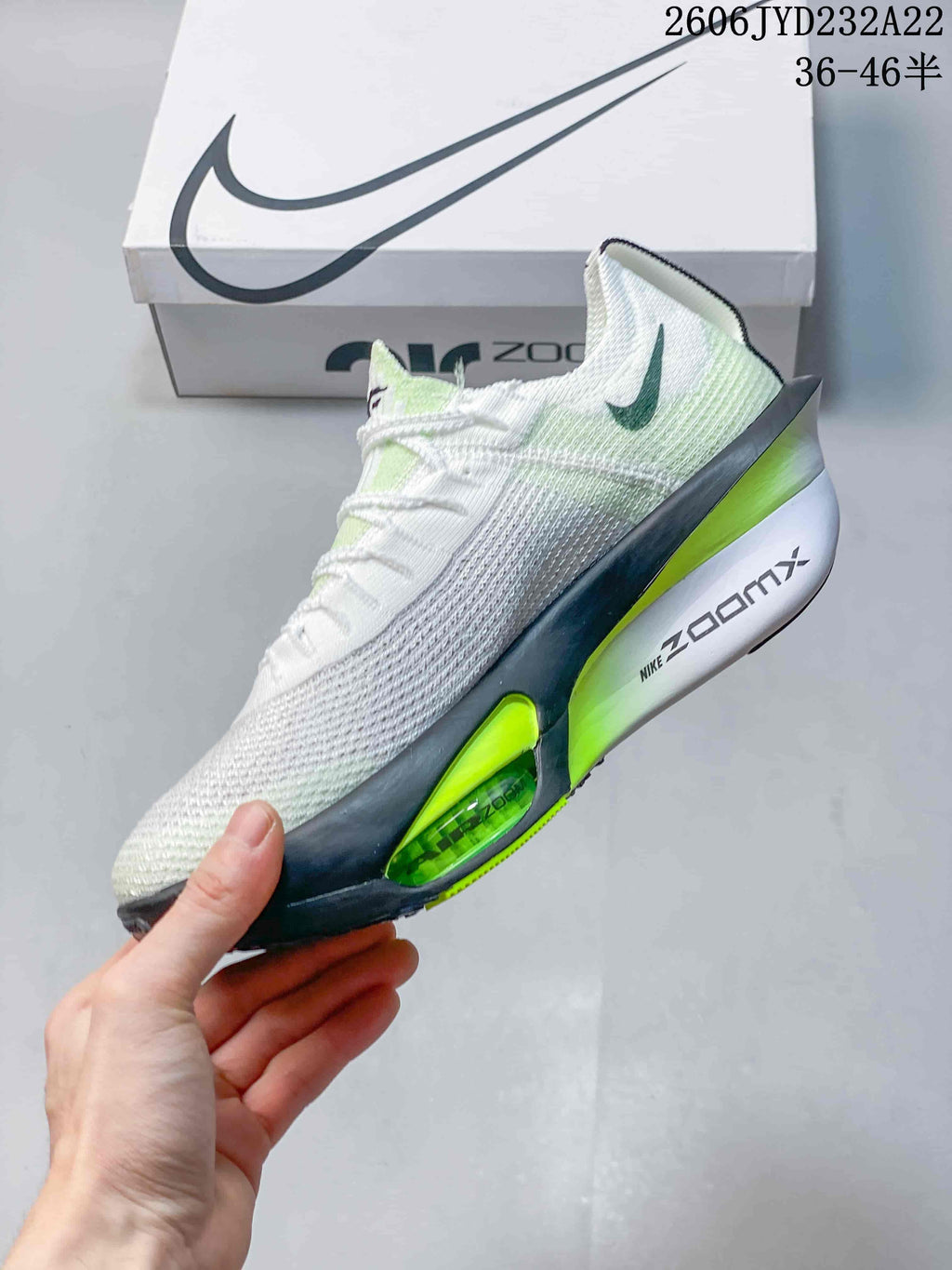 Side profile of the white and bright green Nike running shoe