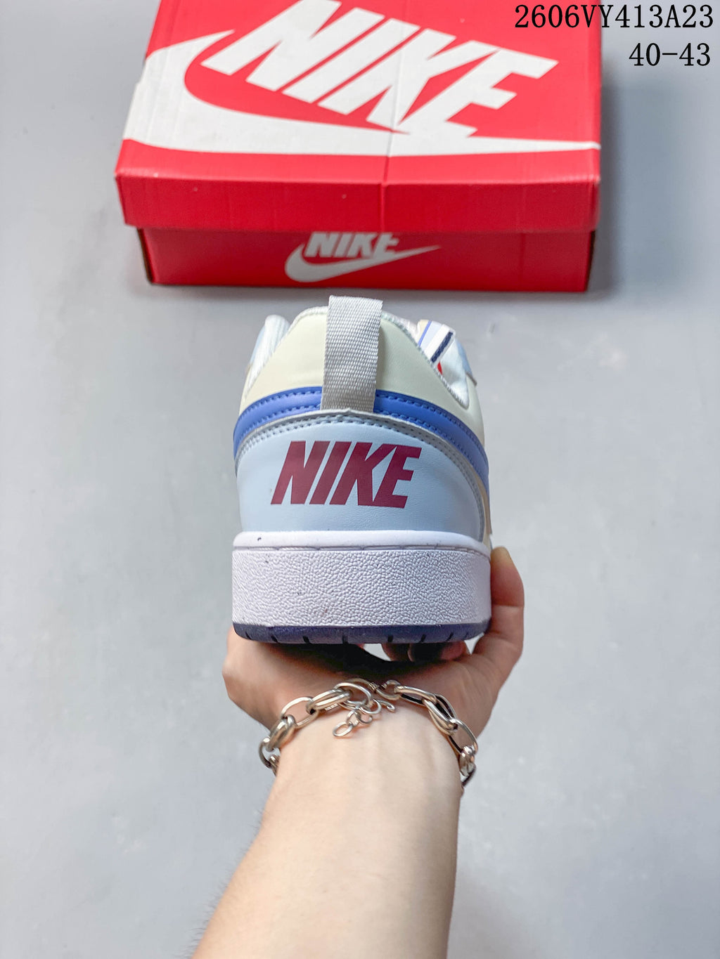 Rear view of a light blue and white NikeCourt Borough 2 Low sneaker