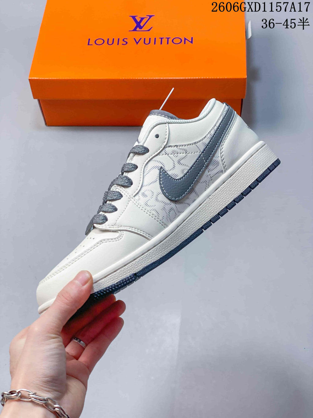 Side profile showing the cream upper, grey Swoosh, and patterned panels