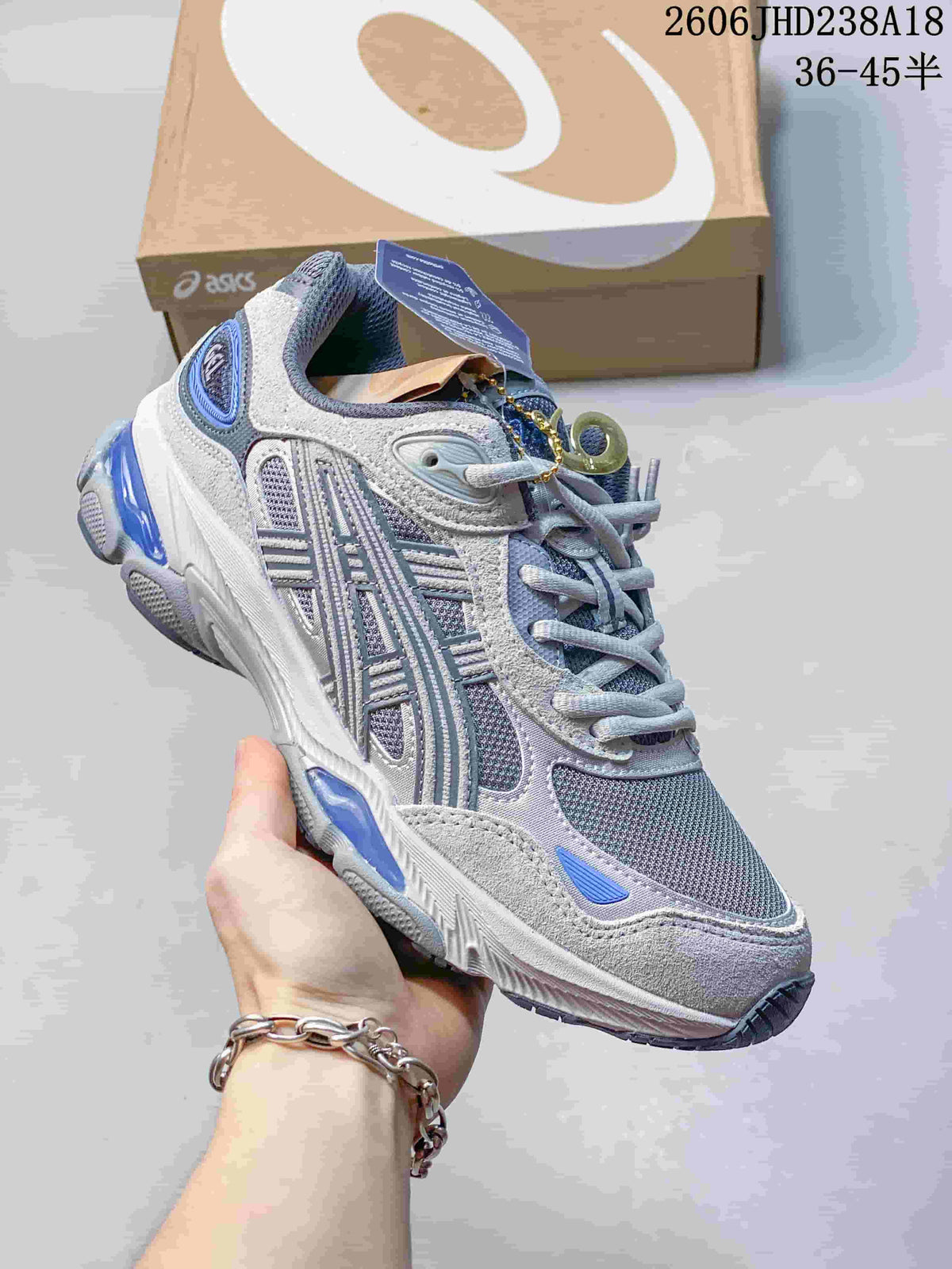 Angled side view of a grey and blue ASICS GEL-NYC 2.0 sneaker