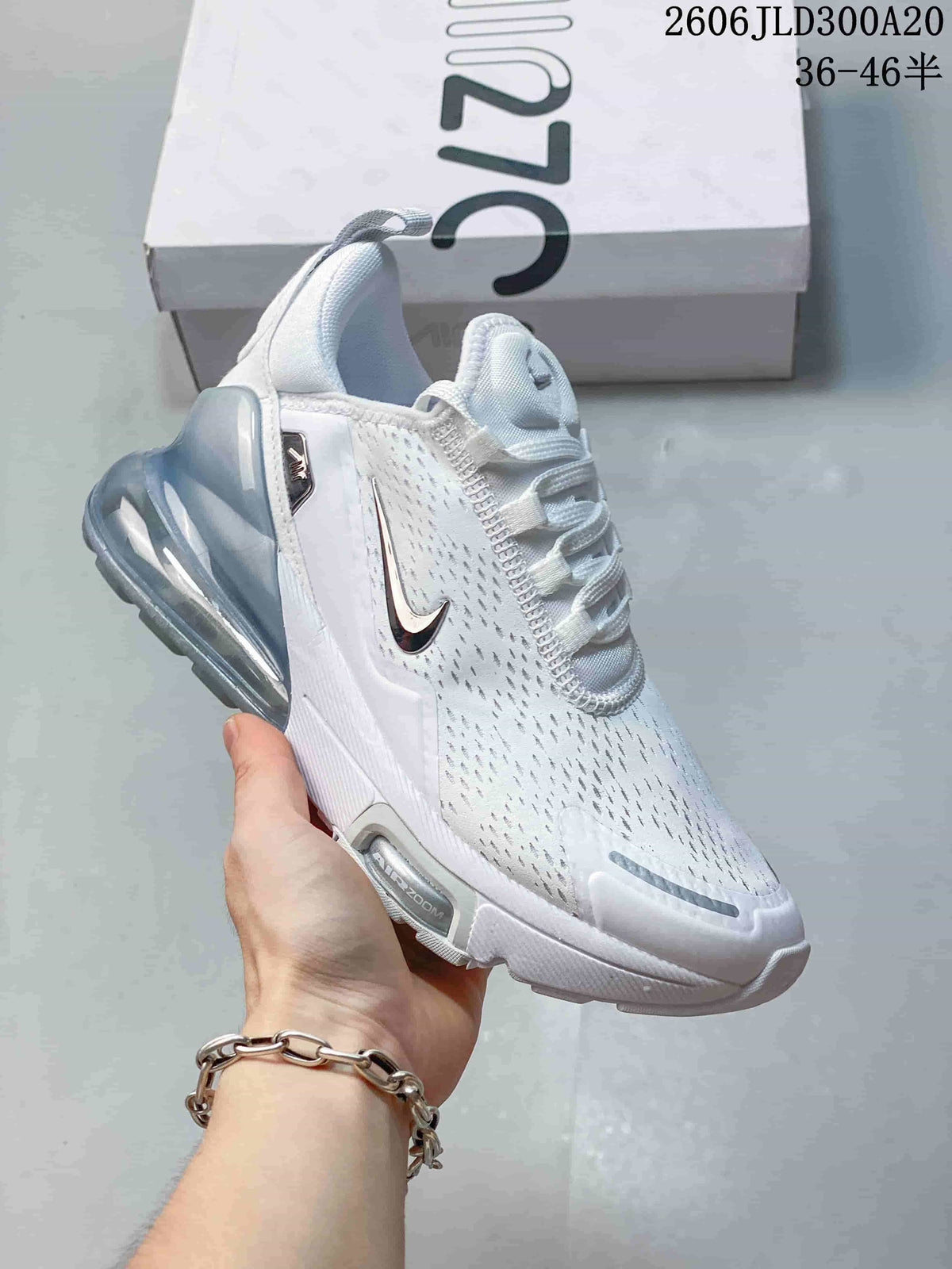 Angled side view of a white Nike Air Max 270 Premium sneaker