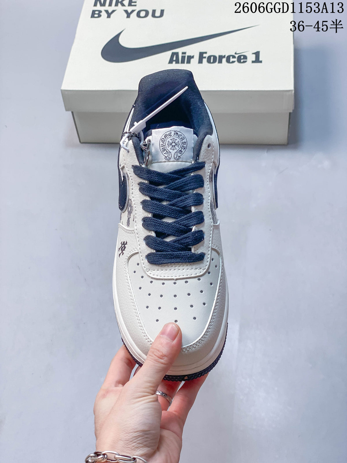 Front view of the sneaker showing its perforated toe and navy laces