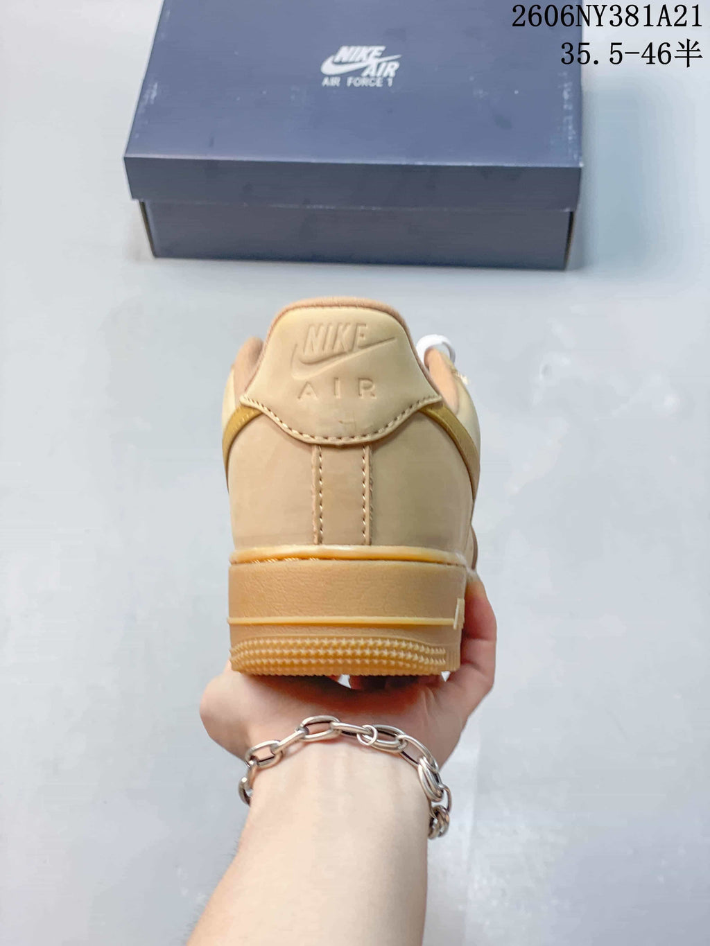 Rear view of the tan low-top sneaker with Nike Air branding