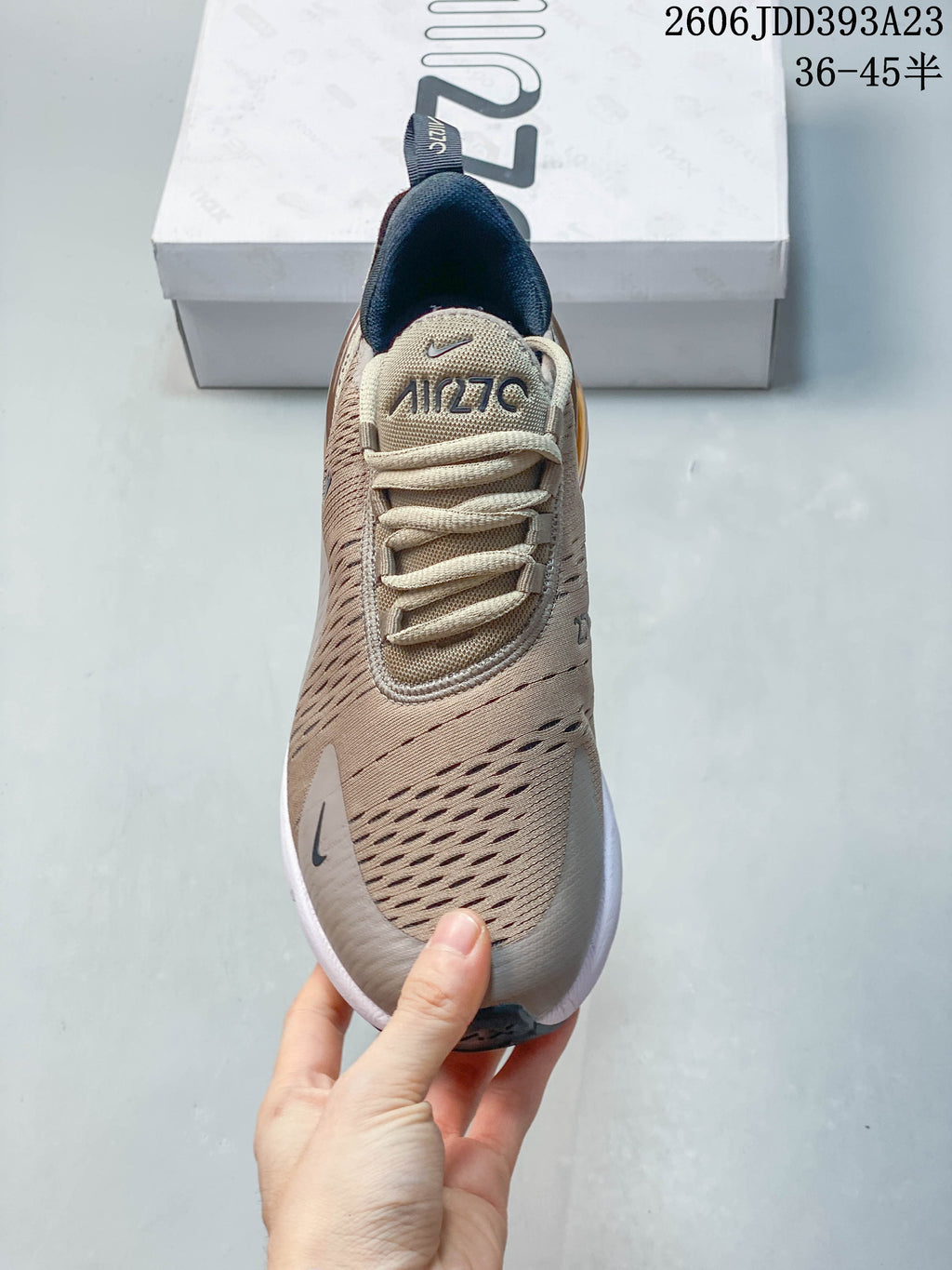 Top view of a beige Nike Air Max 270 sneaker showing its laces and perforated-looking upper.