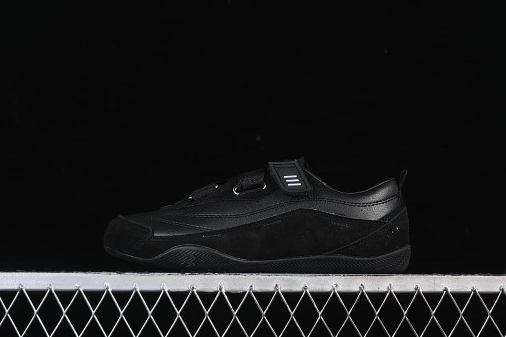 Black Urban Reverie sneaker in side profile against a dark background