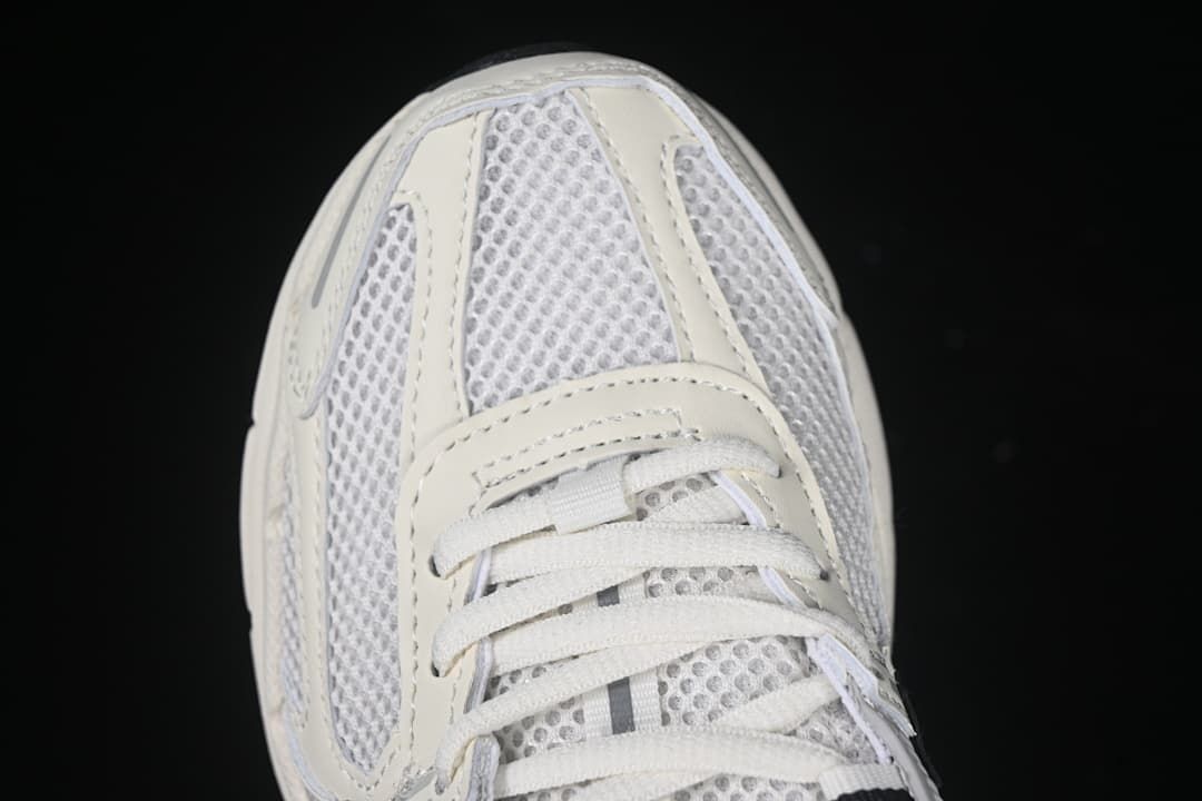 Top-down close-up of the mesh toe box and white laces.